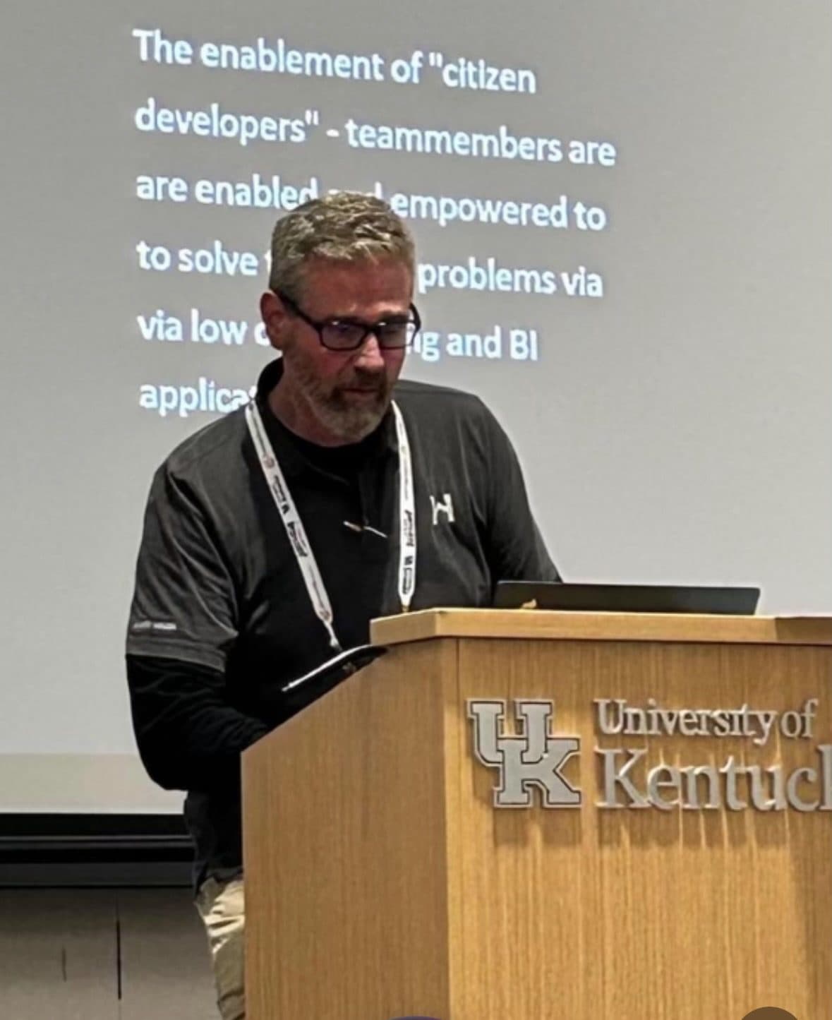 Roger at a University of Kentucky podium giving a talk on enabling citizen developers with low-code tooling and BI.