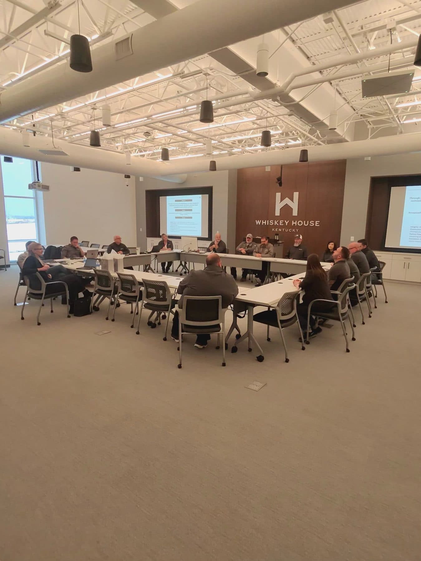 A Whiskey House of Kentucky team meeting on the production floor during commissioning.
